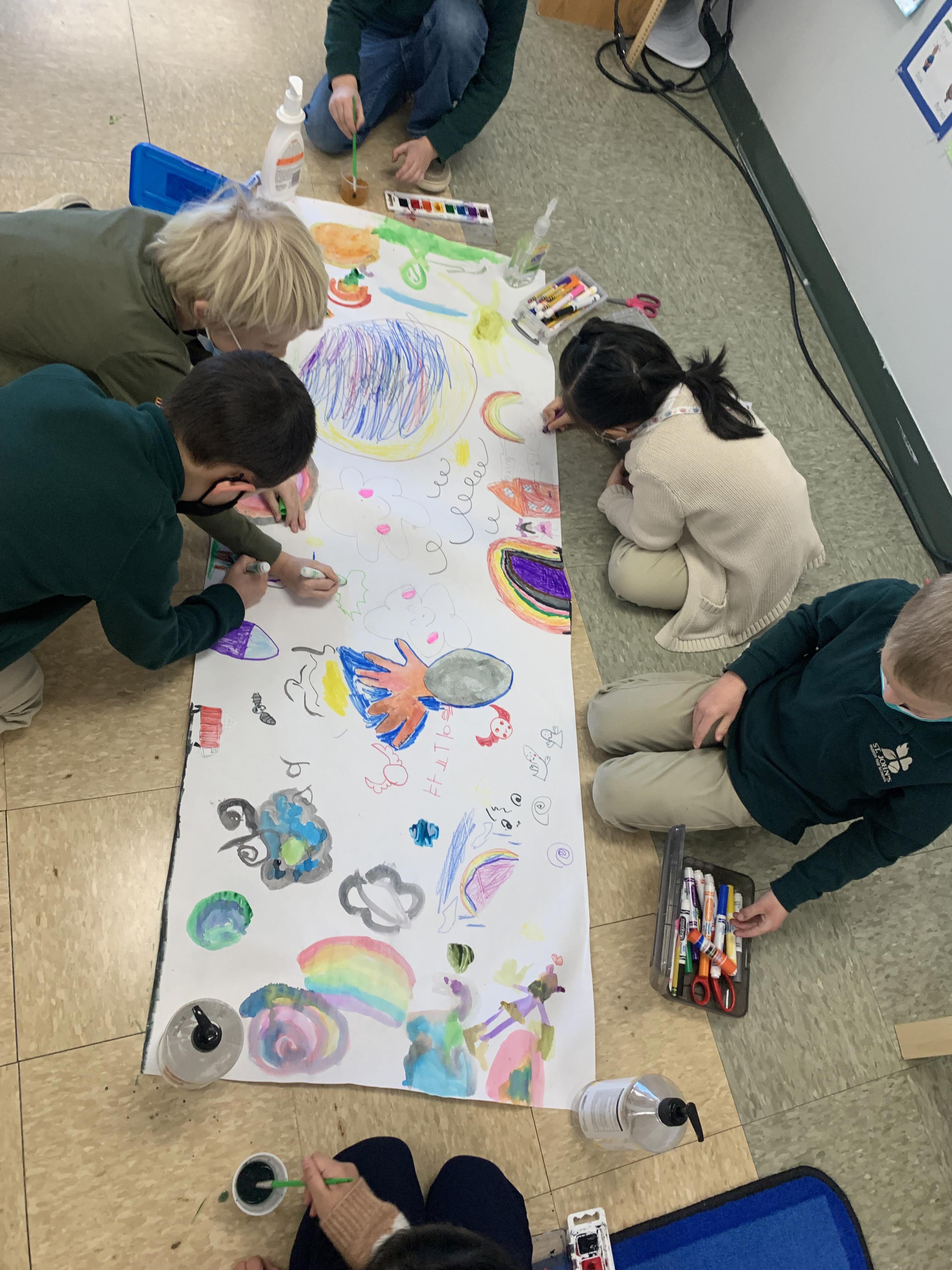 students working together to draw a mural for their classroom