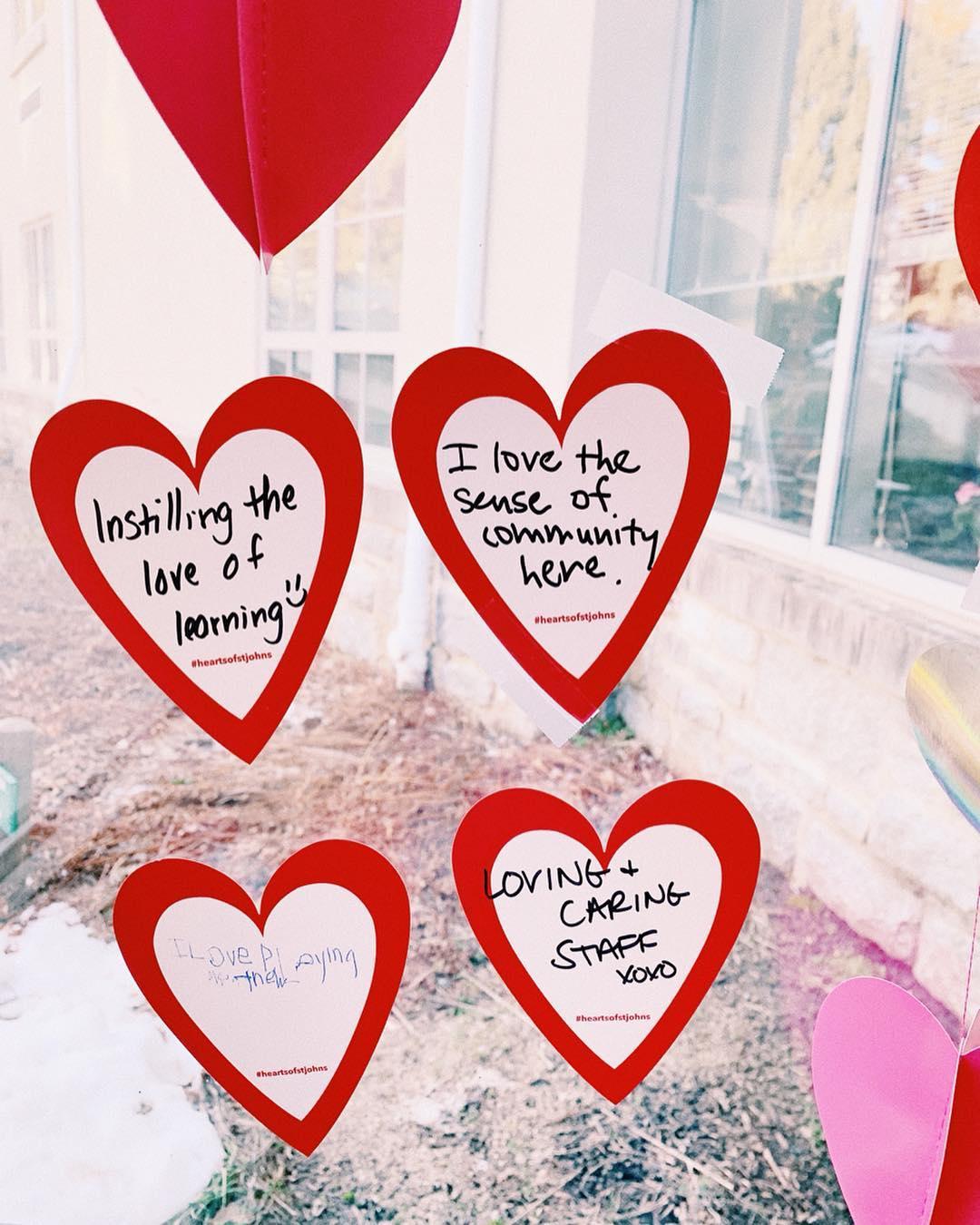 Hearts taped on a window with comments about what people love about St. John's