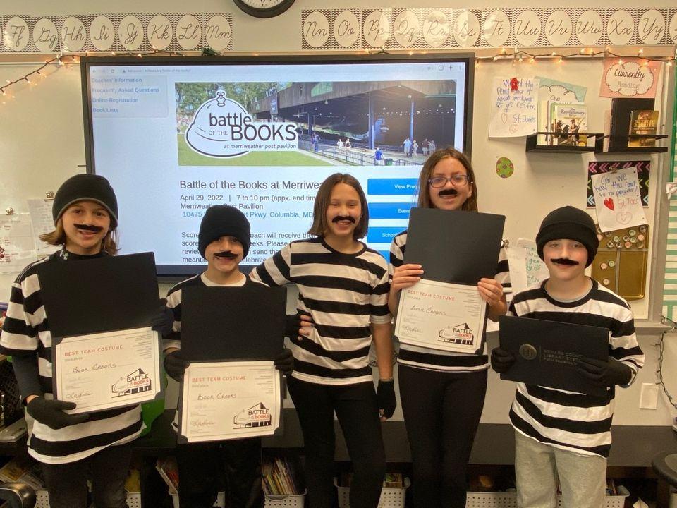 The Book Crooks team - 5th grade students posing for a group picture while holding their winning certificates. 