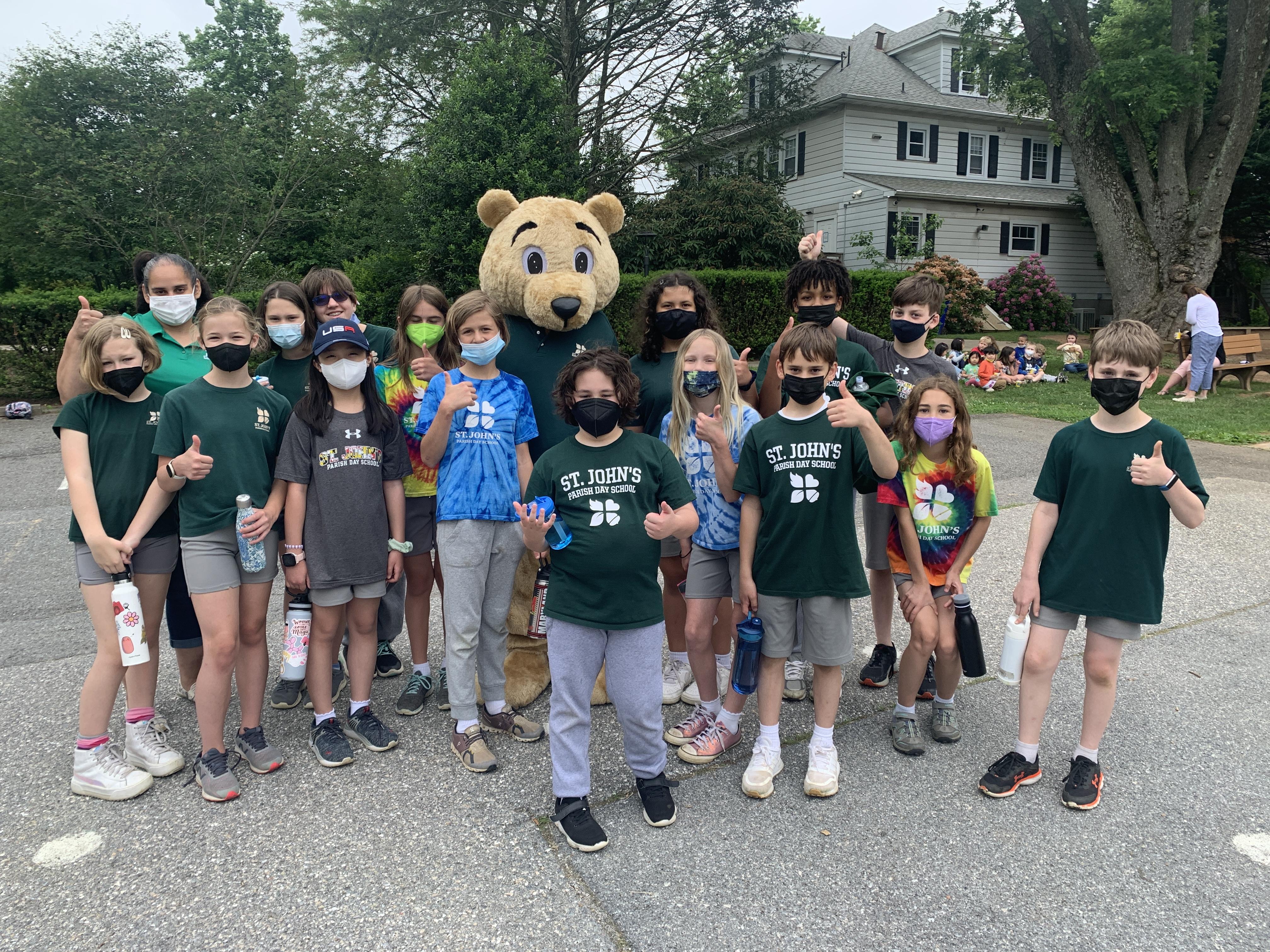 Spirit bear taking a group picture with students
