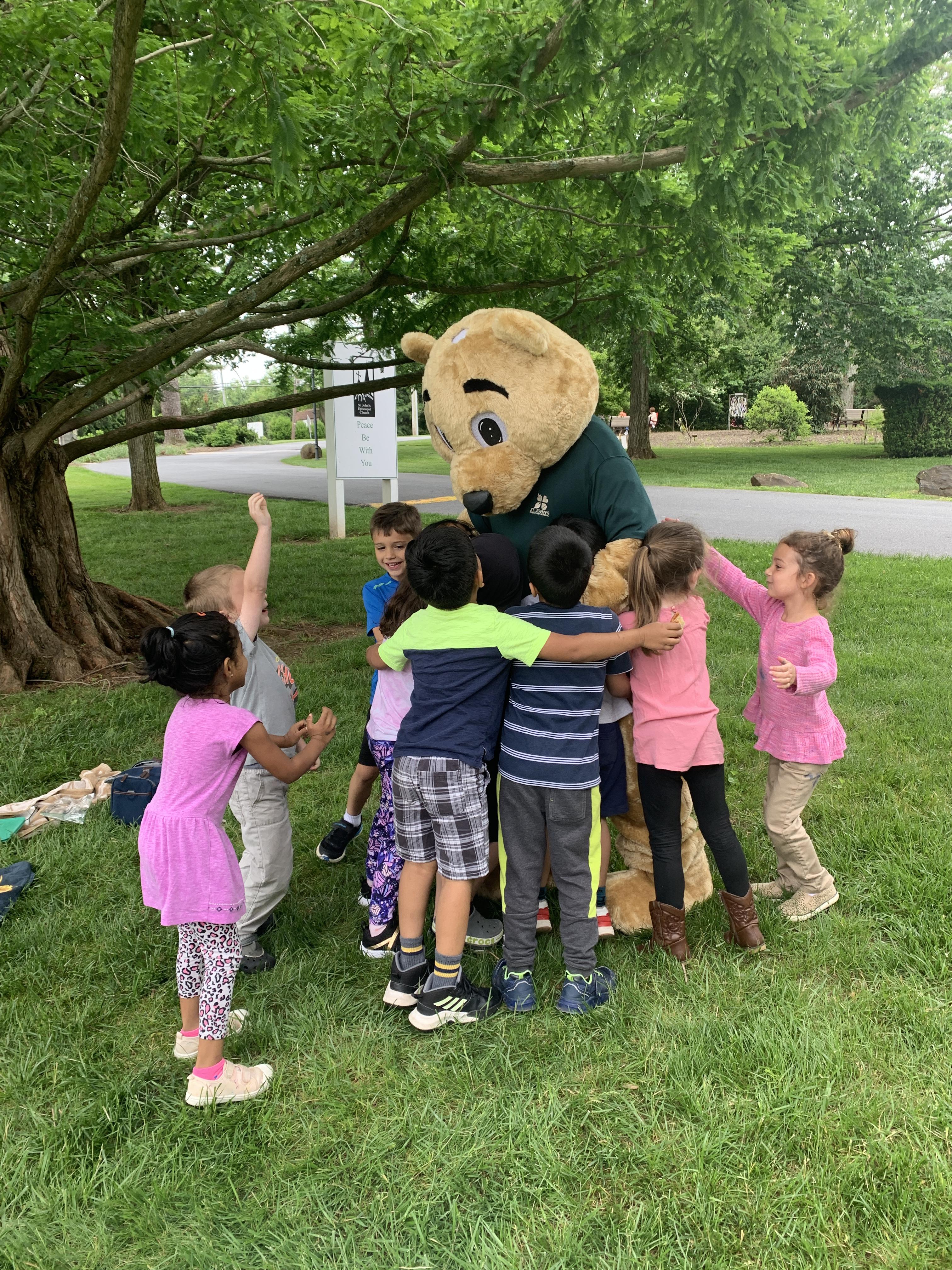 Spirit Bear taking a group picture with students
